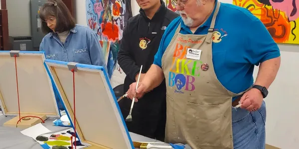 People painting at an art class.